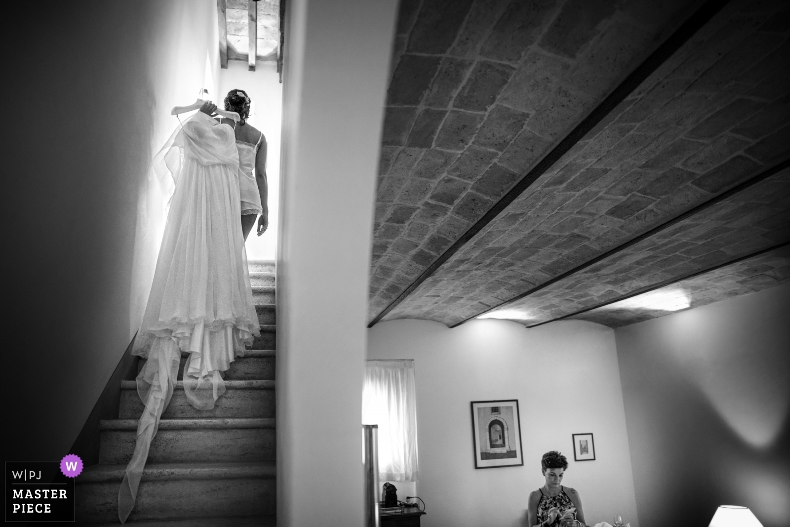 Sposa sale le scale con il suo abito.