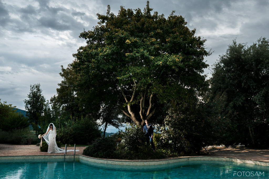 la-sposa-sul-bordo-piscina-con-il-castello-e-le-colline-umbre-sullo-sfondo-atmosfera-romantica
